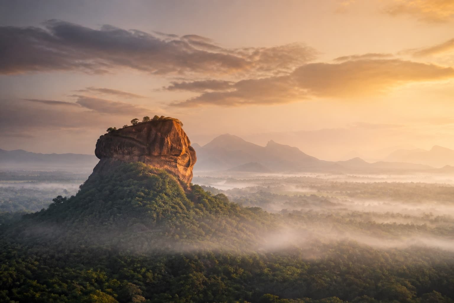 Sigiriya Rock rising above jungle mist