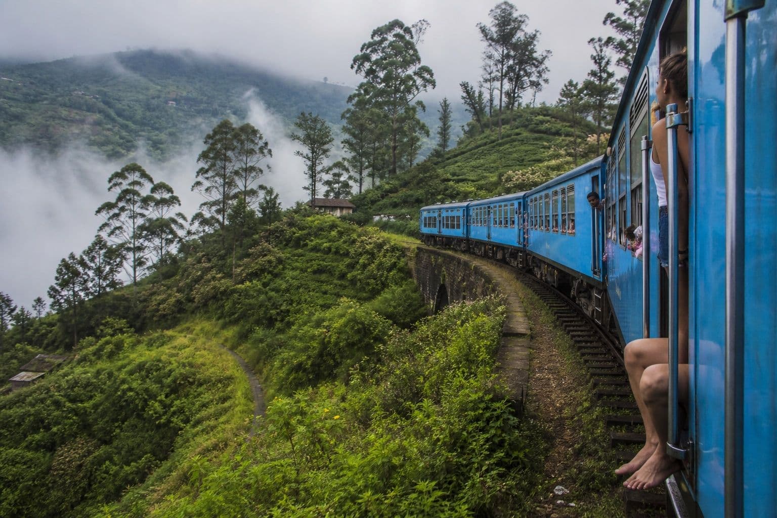 Scenic highland train through misty tea mountains near Ella