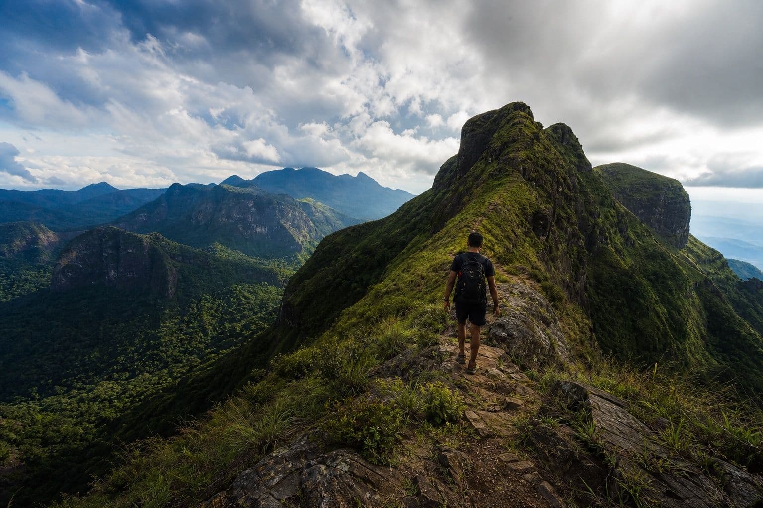 Hiker on a ridge trail above the Knuckles Mountain Range